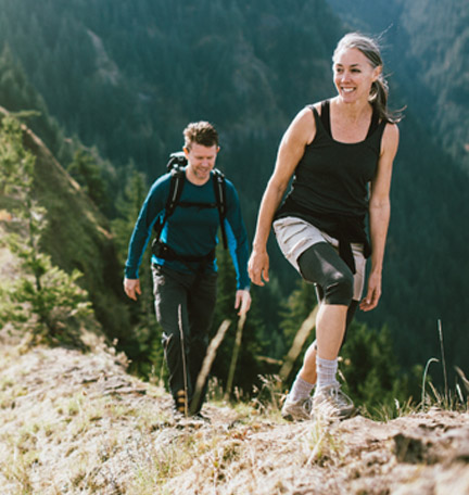 mature couple hiking a mountain